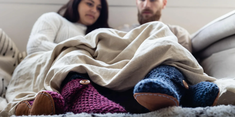 A couple that are wearing Handcrafted slippers